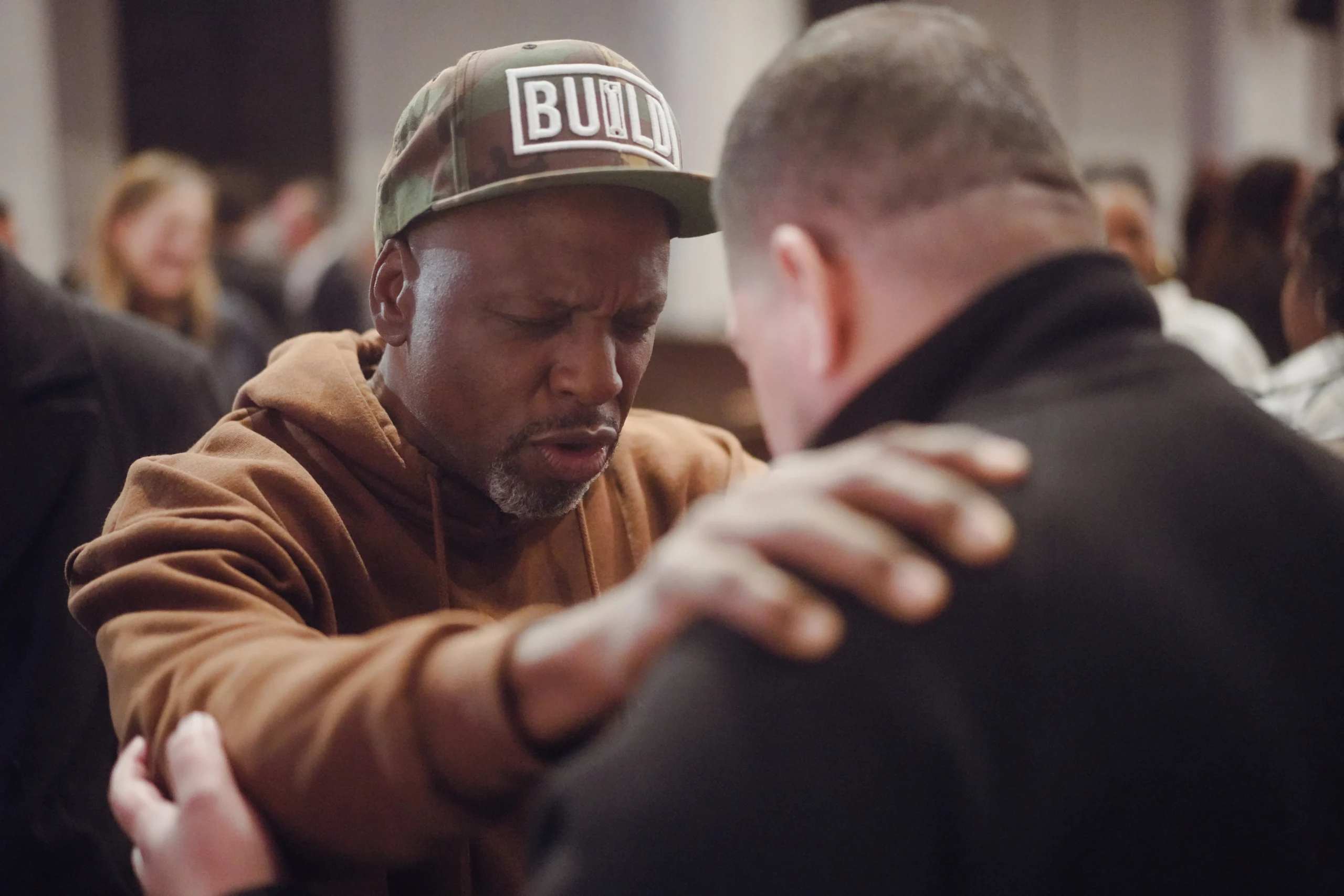 People embracing at a community gathering.
