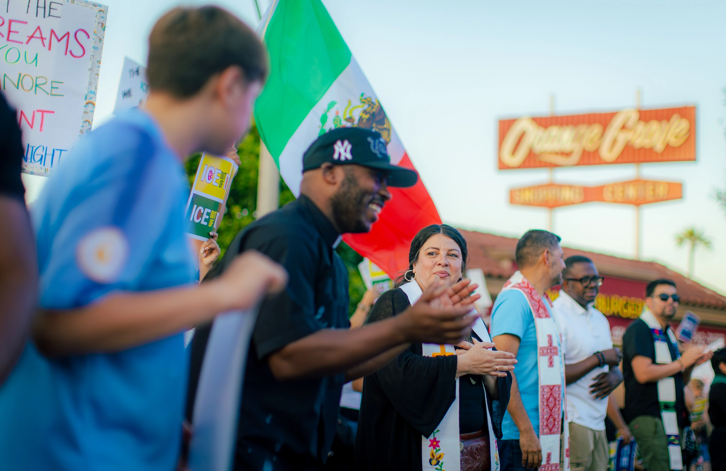 People standing together at an outdoor community gathering.